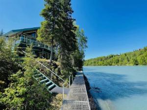 a house on the shore of a body of water at Catch'em AK - Salmon Cove in Soldotna +4 photos