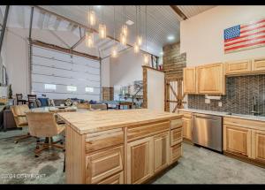 a kitchen with a large island in a room at Catch'em AK - Eagles Nest in Soldotna +12 photos