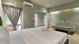 a bedroom with a bed and a sink and a window at Plot 77 by hnh in Baga