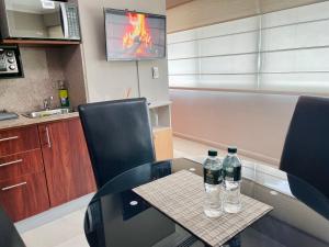two bottles of water sitting on a table in a kitchen at Gallery Suite en Riverfront Puerto Santa Ana in Guayaquil +35 photos