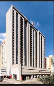 a large white building with balconies on the side of it at Apartamento Águas Claras S4 particular in Águas Claras