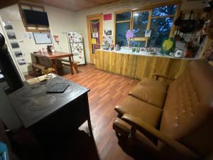 a living room with a couch and a desk at ይሥሓቅ House in Puerto Natales