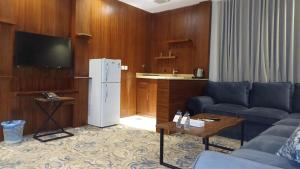 a living room with a couch and a refrigerator at شقق هذا منزلي المخدومة in Riyadh
