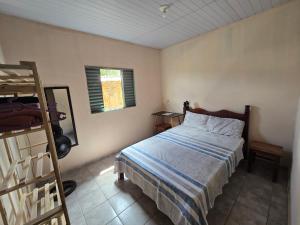 a bedroom with a bed and a ladder and a window at MAEVE Albergue in Goiás