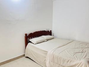 a bed with two pillows on it in a room at HiDot Holidays in Padinjarathara