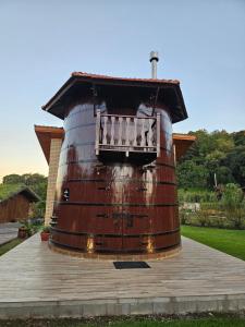 a large barrel with a balcony on top of it at Pousada Botte di Vino in Garibaldi