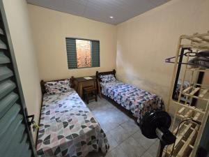 a bedroom with two beds and a desk in it at MAEVE Albergue in Goiás +8 photos