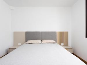 a bedroom with a large white bed with two pillows at Luz de Mafasca in La Hidalga +12 photos