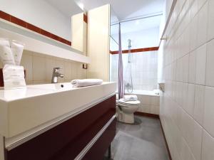 a bathroom with a sink and a toilet at AC Apartaments Apollo Soldeu in Soldeu +24 photos