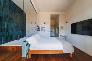 a bedroom with a bed and a bath tub at Palazzo Italia Suites in Bari