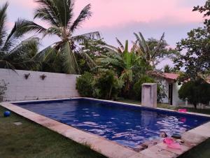 a swimming pool in the yard of a house at Casa da Mari in Caucaia