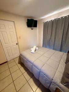 a bedroom with a bed with a stuffed animal on it at Hermosa casa en Jiutepec in Jiutepec