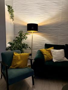 a living room with two chairs and a lamp at Holiday Apartment Lira jacuzzi - sea view- terrace in Mlini +27 photos