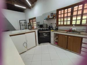 a kitchen with a sink and a stove at Casa de Campo Terra da Paz in Itatiba