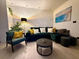 a living room with a green couch and chairs at Holiday Apartment Lira jacuzzi - sea view- terrace in Mlini