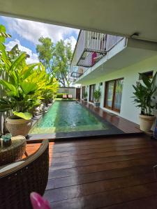a swimming pool in the middle of a building at Villa Fireflies in Darmasaba