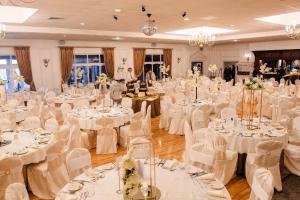 a banquet hall with white tables and white chairs at The Blue Haven Kilcar in Donegal