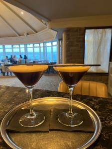 two martini glasses sitting on a tray on a table at The Blue Haven Kilcar in Donegal