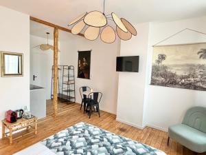 a bedroom with a bed and a chair and a table at Résidence Gaïa - Etretat in Étretat