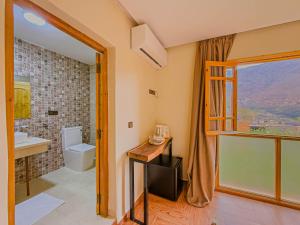 a bathroom with a sink and a toilet and a window at Targa Imoula Luxe in Imlil +89 photos