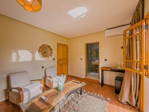 a living room with a couch and a table at Targa Imoula Luxe in Imlil