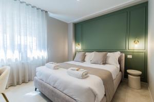 a bedroom with two beds with towels on them at Campo's Guest House Airport in Bari +87 photos