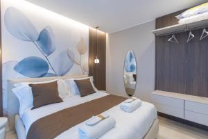a bedroom with a large bed with towels on it at Campo's Guest House Airport in Bari