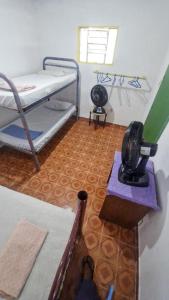 a room with two bunk beds and a fan at Carioca Lapa Hostel in Rio de Janeiro
