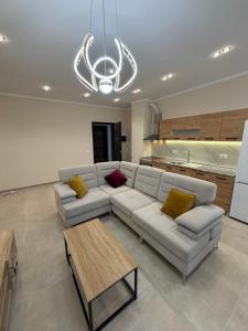 a living room with a couch and a table at Tirana Urban Nest in Tirana