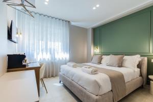 a bedroom with a large bed and a window at Campo's Guest House Airport in Bari