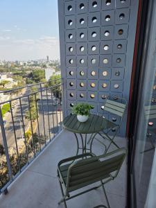 a table and chairs on a balcony with a view at Apartment in downtown Zapopan in Guadalajara