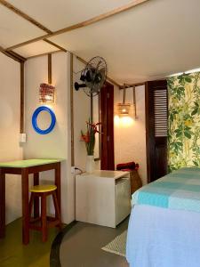 a bedroom with a bed and a table and a desk at Casa Acquamarina in Atins +92 photos