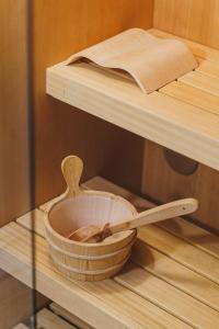 a wooden spoon and a bowl on a glass shelf at Palazzo Italia Suites in Bari