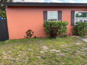 a house with two bushes in front of it at Sweet Escape Cozy Studio in Fort Lauderdale