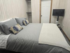 a bedroom with a large bed with pillows on it at alojamiento Santa Rosa 744 in Puerto Varas
