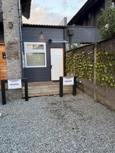 a house with two signs in front of it at alojamiento Santa Rosa 744 in Puerto Varas