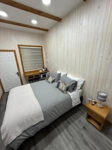 a bedroom with a large bed with pillows at alojamiento Santa Rosa 744 in Puerto Varas
