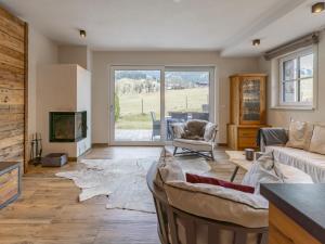 a living room with a couch and a tv at Schneeflocke Leogang in Leogang