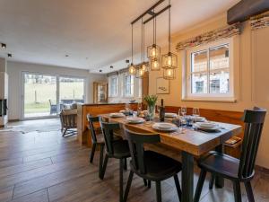 a dining room with a large wooden table and chairs at Schneeflocke Leogang in Leogang