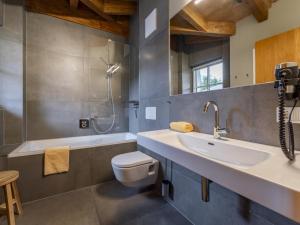 a bathroom with a sink and a toilet and a shower at Schneeflocke Leogang in Leogang +34 photos