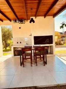 a patio with a table and chairs and a fireplace at Complejo Anjana in Federación