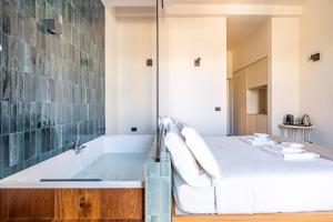 a bathroom with a tub and a bed at Palazzo Italia Suites in Bari +87 photos