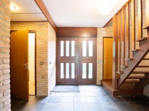 a hallway with a wooden door and stairs at Steenenburg Zicht in Nieuwkuijk