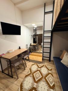a loft apartment with a dining room and a loft bed at Blacky Hostel and Apartments in Cusco
