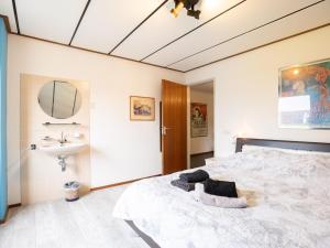 a bedroom with a large bed and a sink at Steenenburg Zicht in Nieuwkuijk +39 photos