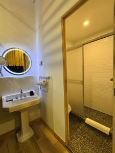 a bathroom with a sink and a shower at Blacky Hostel and Apartments in Cusco +53 photos