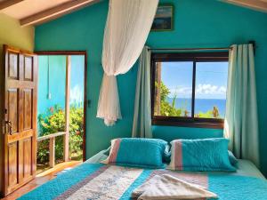 a blue bedroom with a bed and a window at Casa Jade in Drake