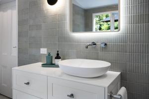 a bathroom with a white sink and a mirror at Little Wombat Daylesford in Daylesford +11 photos