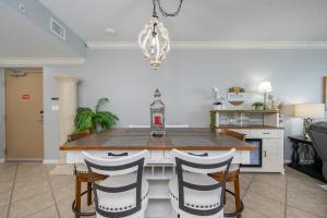 a kitchen with a dining room table and chairs at Phoenix X 1504 condo in Orange Beach
