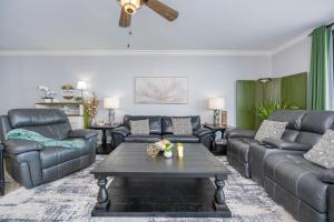 a living room with leather couches and a coffee table at Phoenix X 1504 condo in Orange Beach